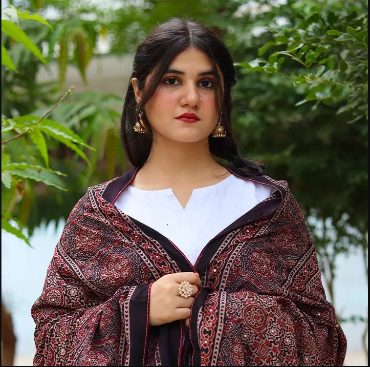 Model wearing a red and black Sindhi Ajrak shawl